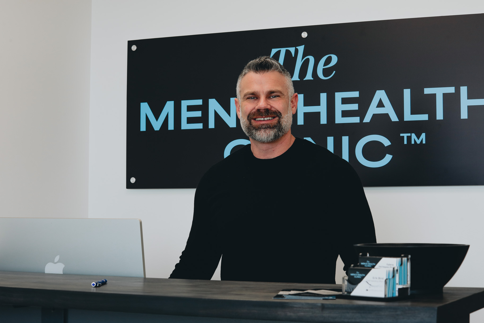 Erik Bird at the front desk of The Men's Health Clinic