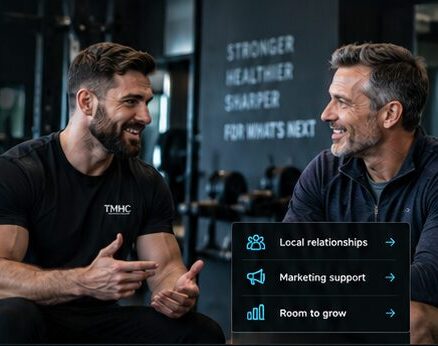 Two men talking in a TMHC gym